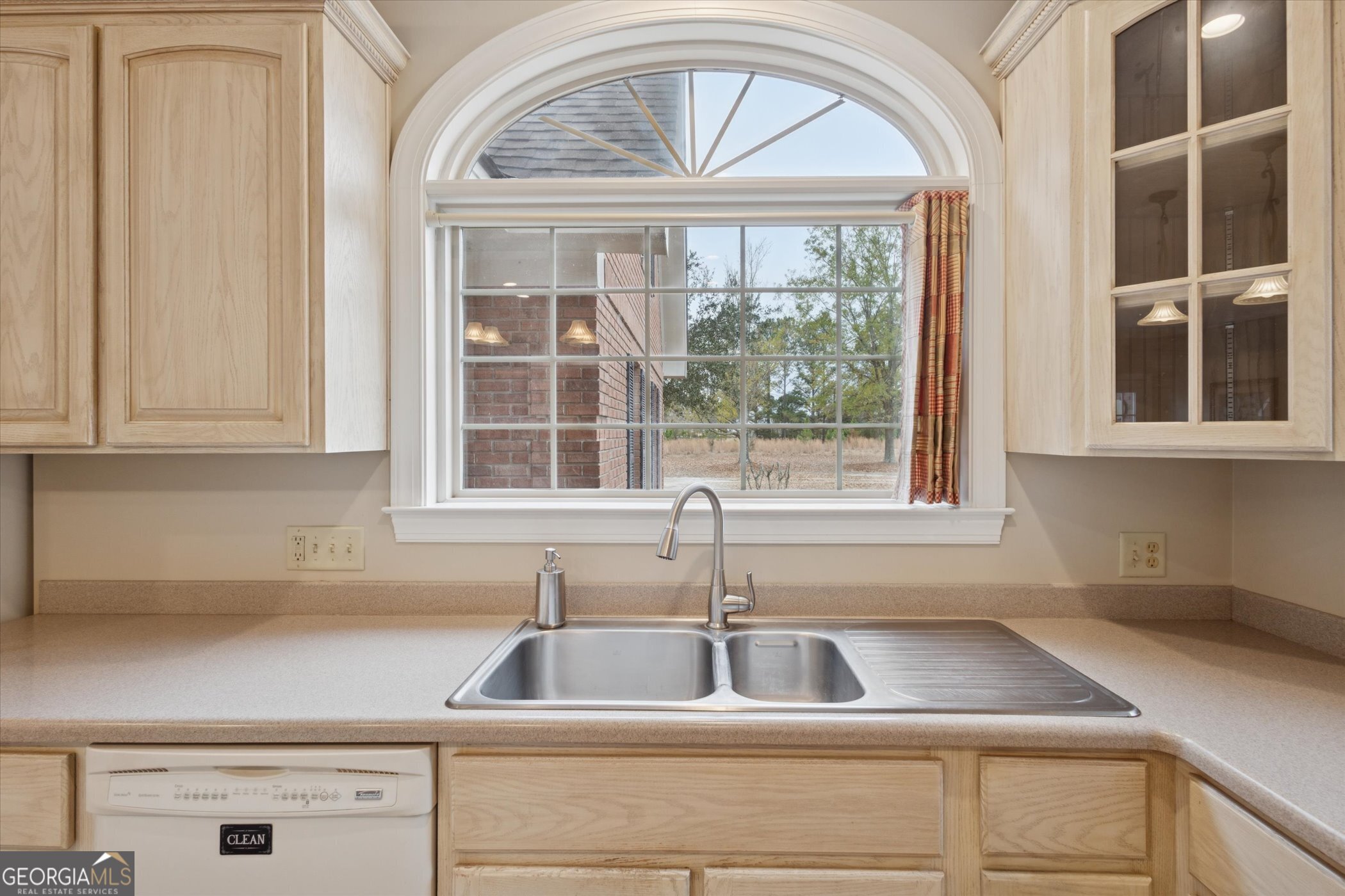 10544 Burkhalter Road Statesboro, GA 30461 - Photo 19 of 67 a kitchen with a sink and cabinets