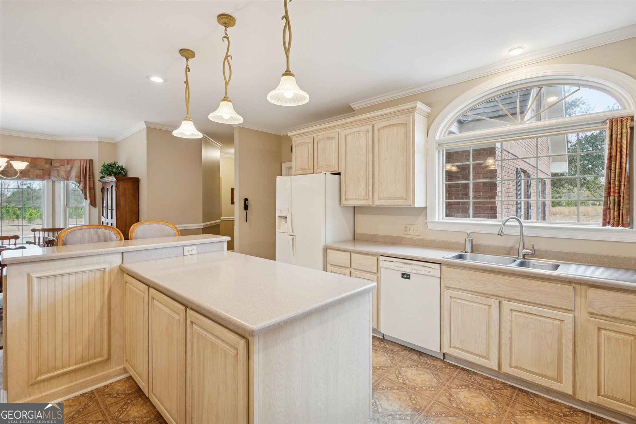 10544 Burkhalter Road Statesboro, GA 30461 - Photo 20 of 67 a kitchen with a sink dishwasher a stove and white cabinets with wooden floor