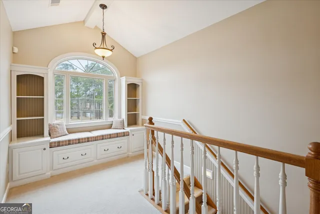an empty room with a ceiling fan and a window