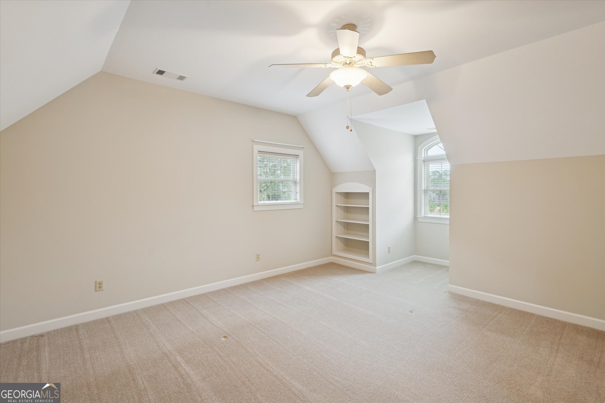 10544 Burkhalter Road Statesboro, GA 30461 - Photo 31 of 67 an empty room with windows and fan