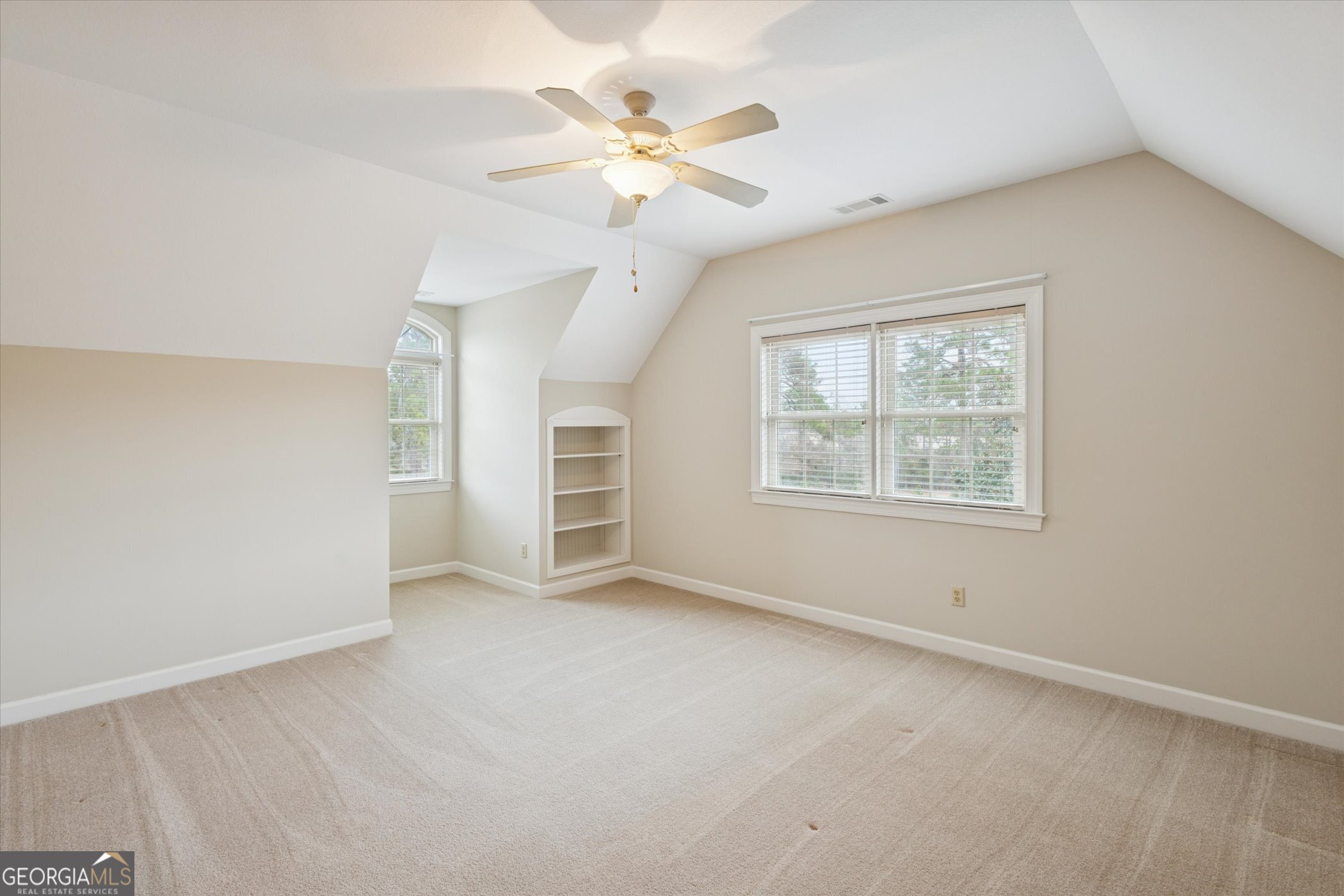 10544 Burkhalter Road Statesboro, GA 30461 - Photo 35 of 67 an empty room with windows and ceiling fan