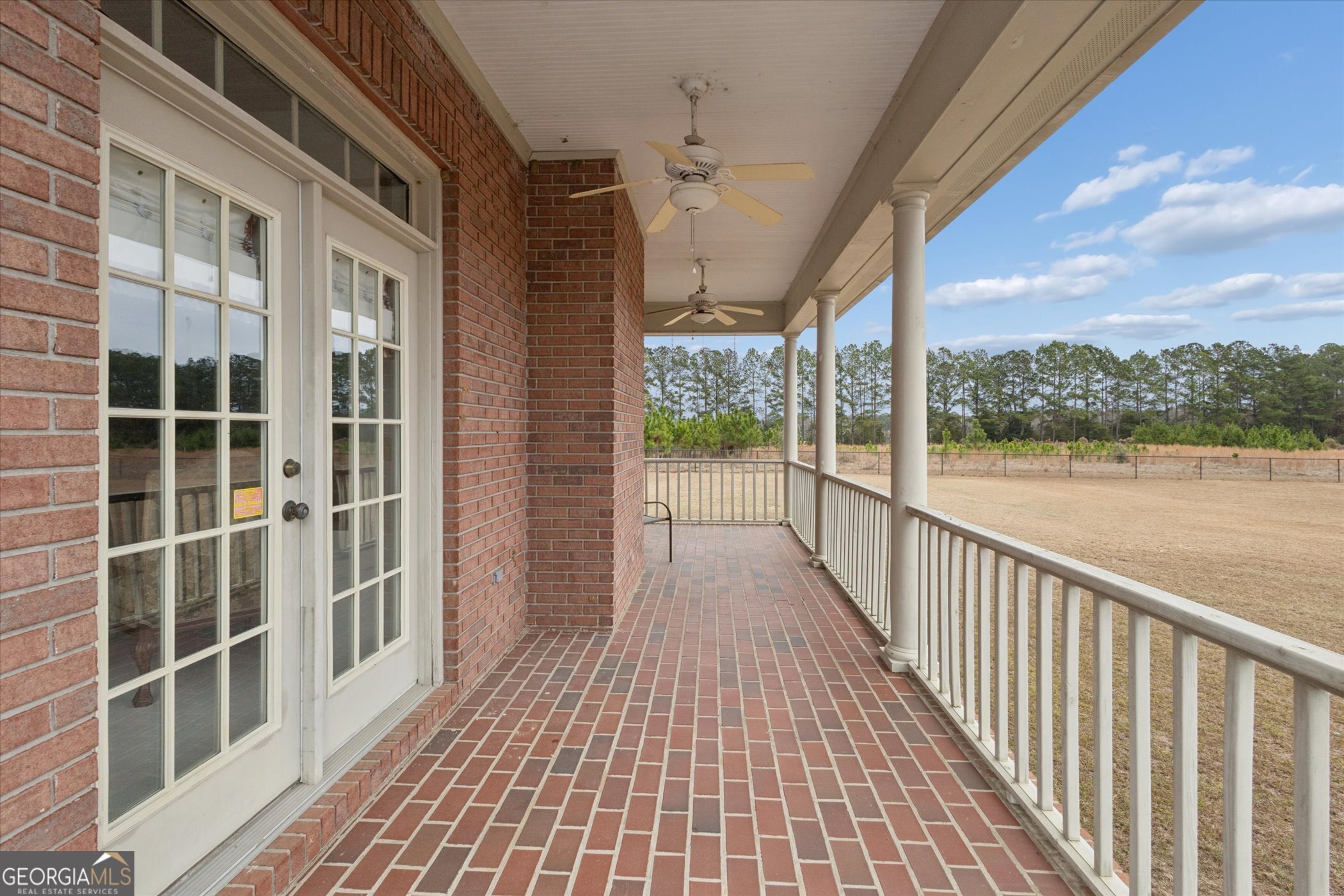 10544 Burkhalter Road Statesboro, GA 30461 - Photo 45 of 67 a view of a balcony with wooden floor and floor to ceiling windows