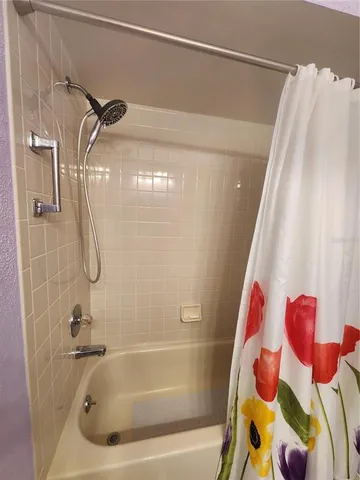 a bathroom with a bathtub and shower