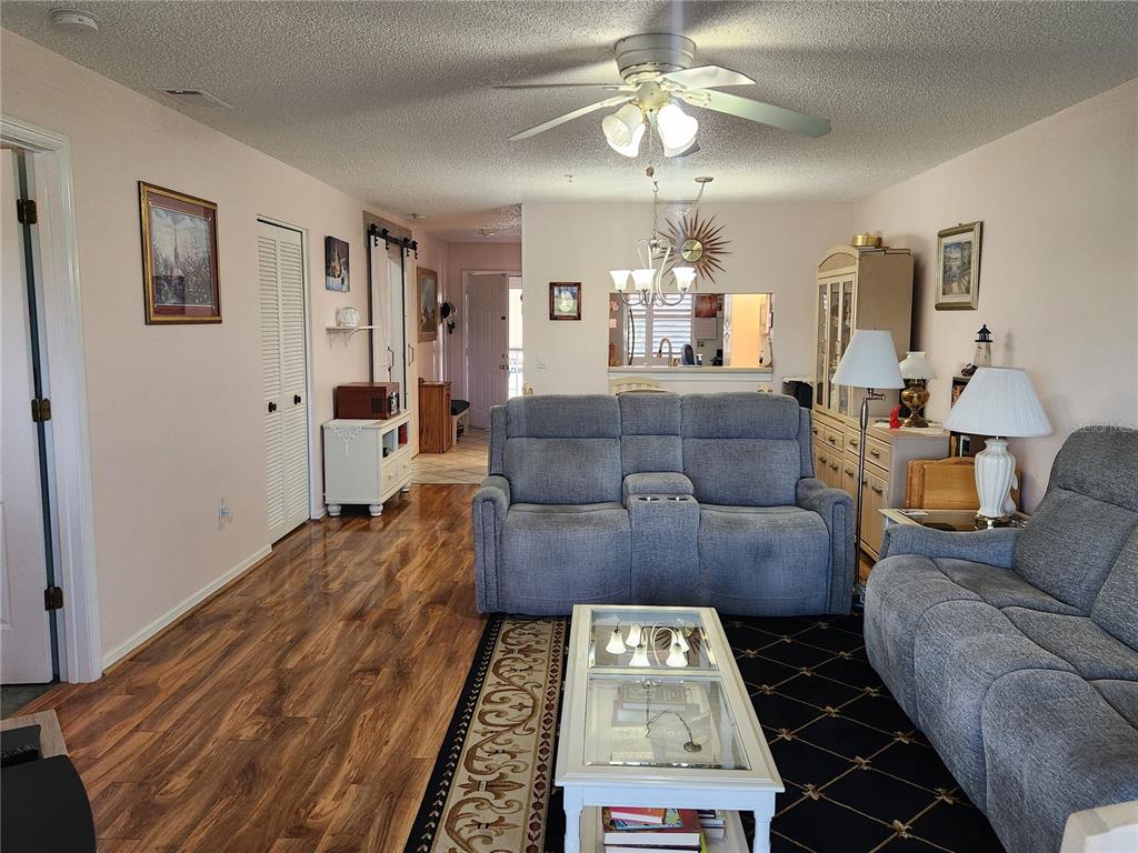 6505 Stone River Road, Unit 304 Bradenton, FL 34203 - Photo 4 of 38 a living room with furniture and a chandelier