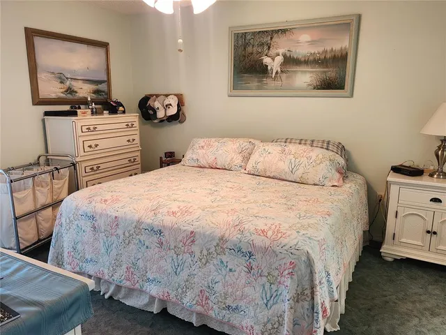 a bedroom with a bed and dresser