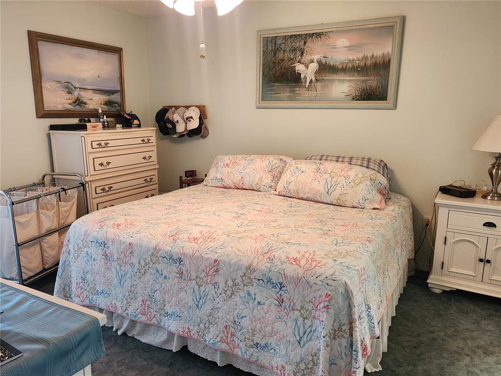 6505 Stone River Road, Unit 304 Bradenton, FL 34203 - Photo 9 of 38 a bedroom with a bed and dresser