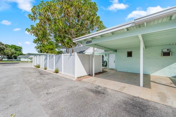 9302 Southwest 5th Street, Unit B Boca Raton, FL 33428 - Photo 1 of 26 a view of backyard with small cabin and wooden fence
