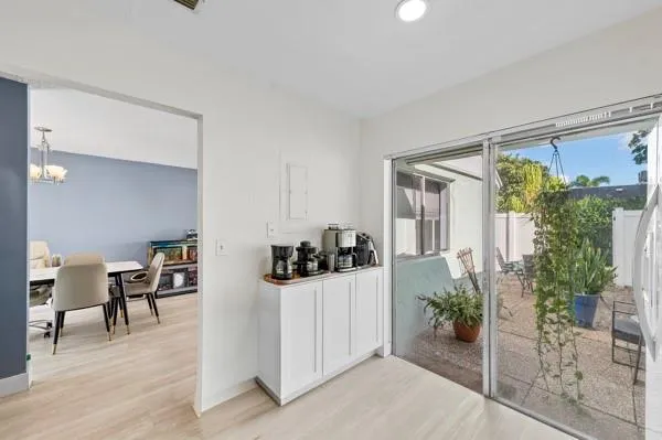 a view of a livingroom with furniture and floor to ceiling window
