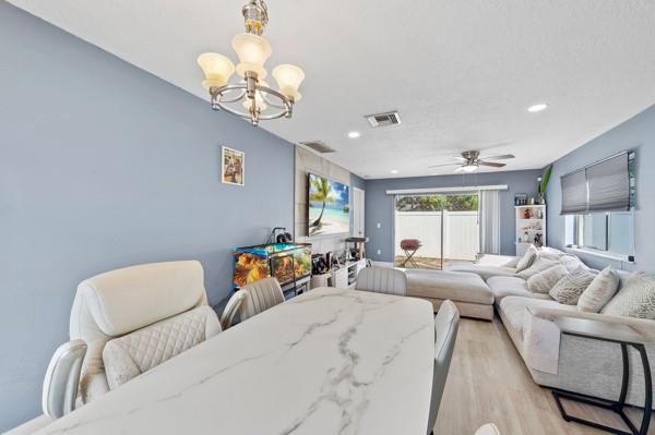 9302 Southwest 5th Street, Unit B Boca Raton, FL 33428 - Photo 15 of 26 a living room with furniture a chandelier and a window