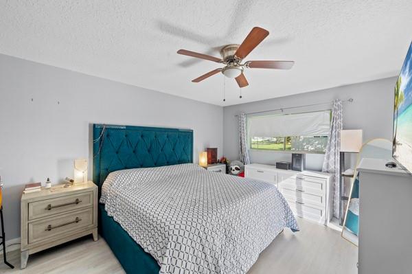 9302 Southwest 5th Street, Unit B Boca Raton, FL 33428 - Photo 17 of 26 a bedroom with a bed and a dresser