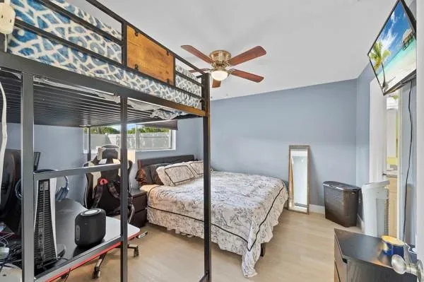 a bedroom with a bed and a flat screen tv