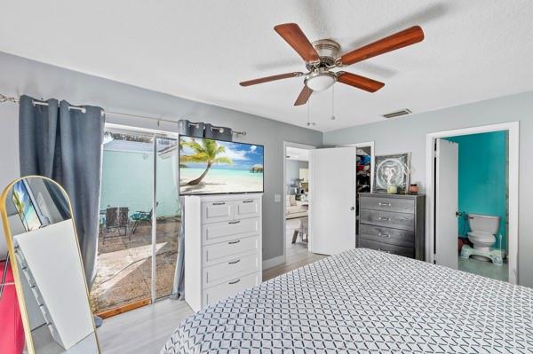 9302 Southwest 5th Street, Unit B Boca Raton, FL 33428 - Photo 21 of 26 a bedroom with a bed and a television