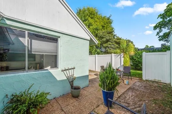 a view of a patio with table and chairs and potted plants