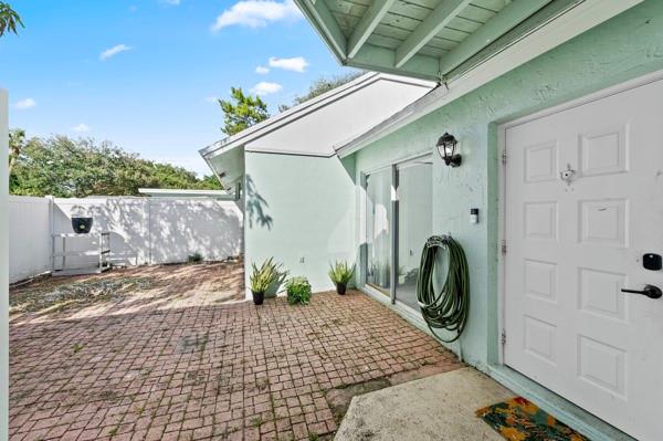 9302 Southwest 5th Street, Unit B Boca Raton, FL 33428 - Photo 4 of 26 a front view of a house with garden