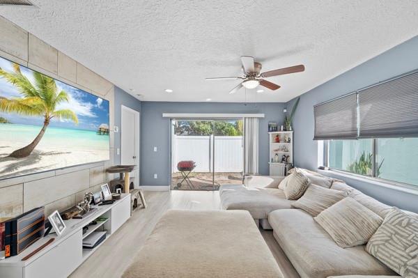 9302 Southwest 5th Street, Unit B Boca Raton, FL 33428 - Photo 6 of 26 a living room with furniture a large window with a flat screen tv