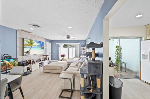 9302 Southwest 5th Street, Unit B Boca Raton, FL 33428 - Photo 10 of 26 a living room with furniture and a flat screen tv