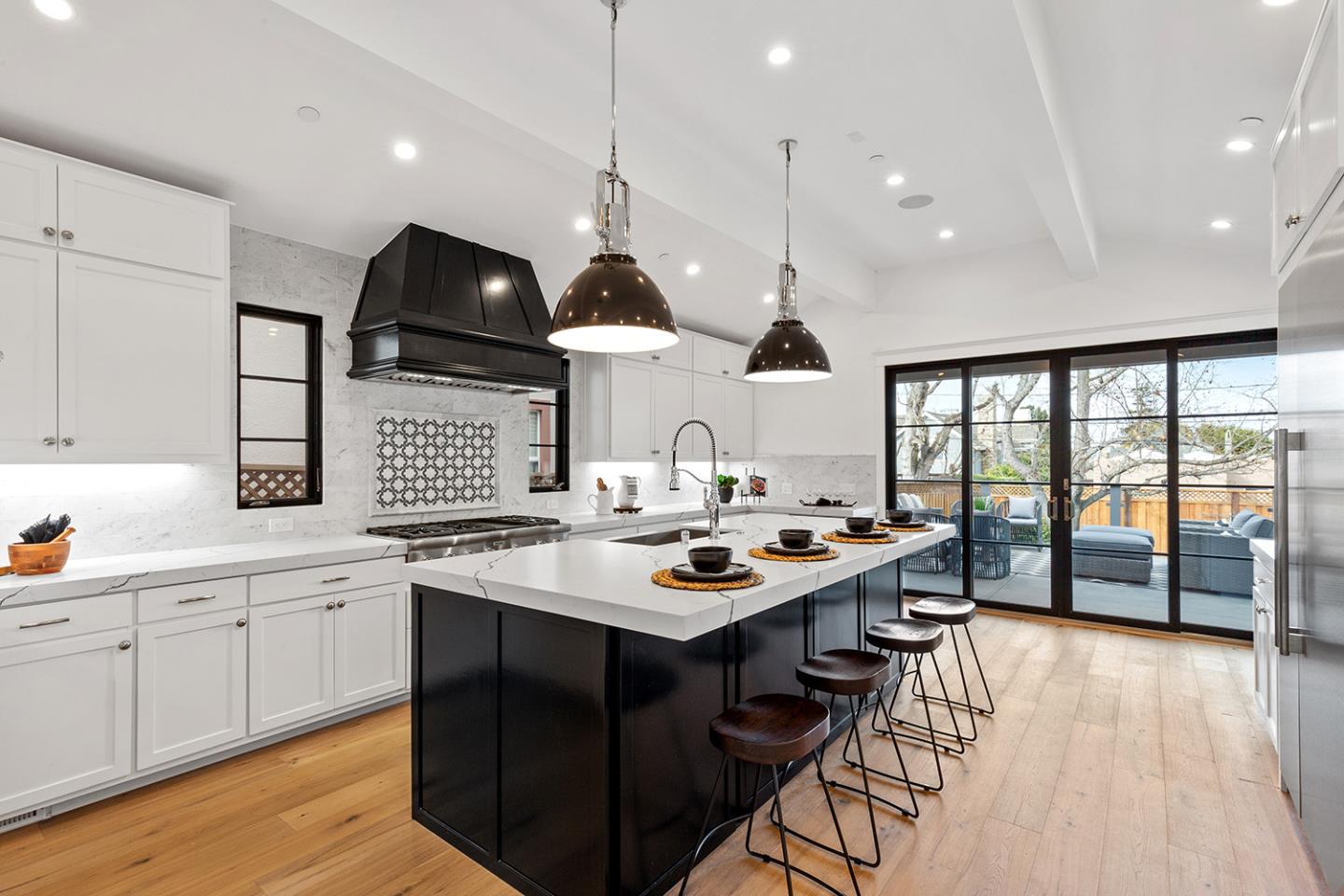 1324 Castillo Avenue Burlingame, CA 94010 - Photo 16 of 50 a kitchen with stainless steel appliances a sink a stove and a wooden floors