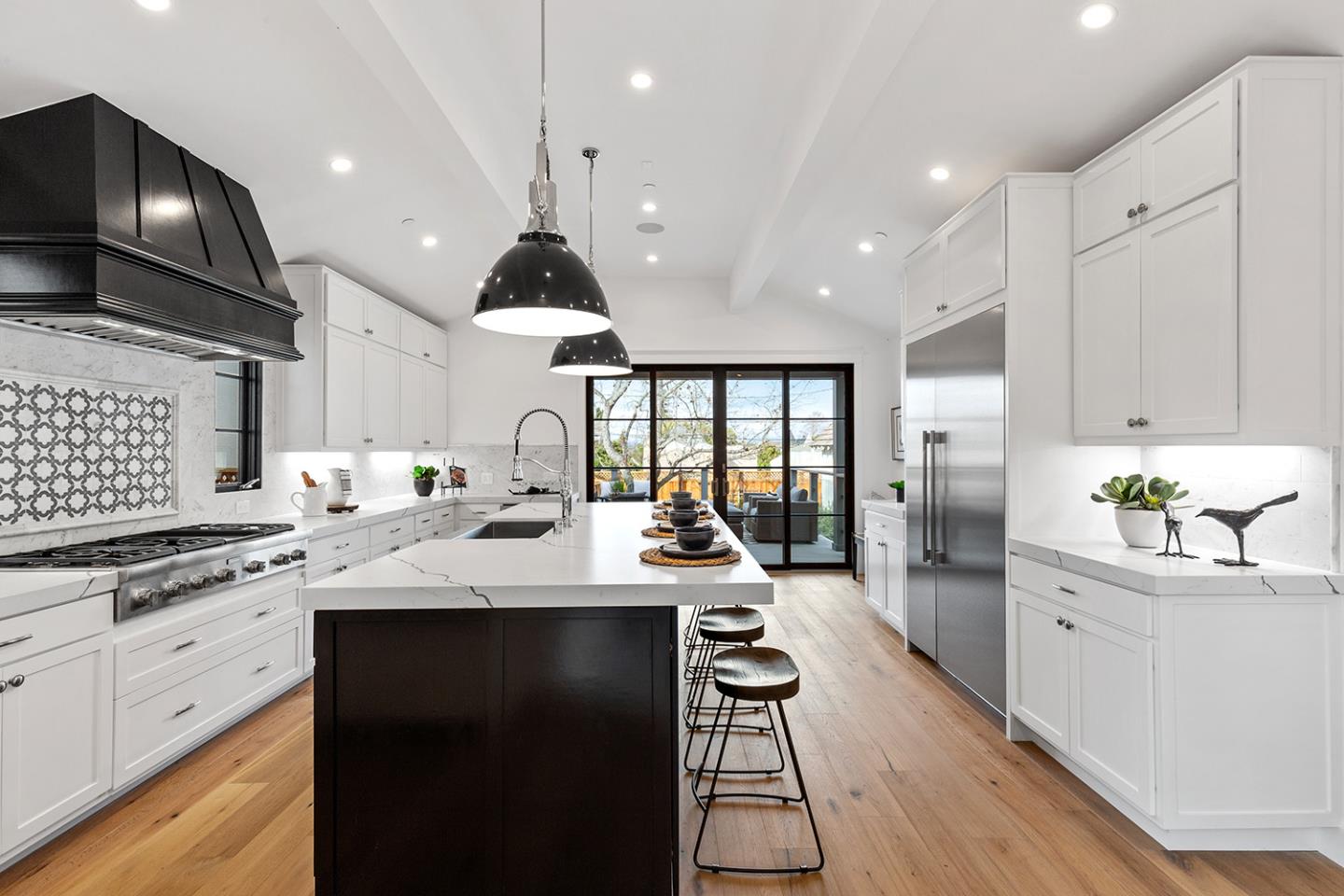 1324 Castillo Avenue Burlingame, CA 94010 - Photo 17 of 50 a kitchen with stainless steel appliances kitchen island granite countertop a sink a stove and cabinets