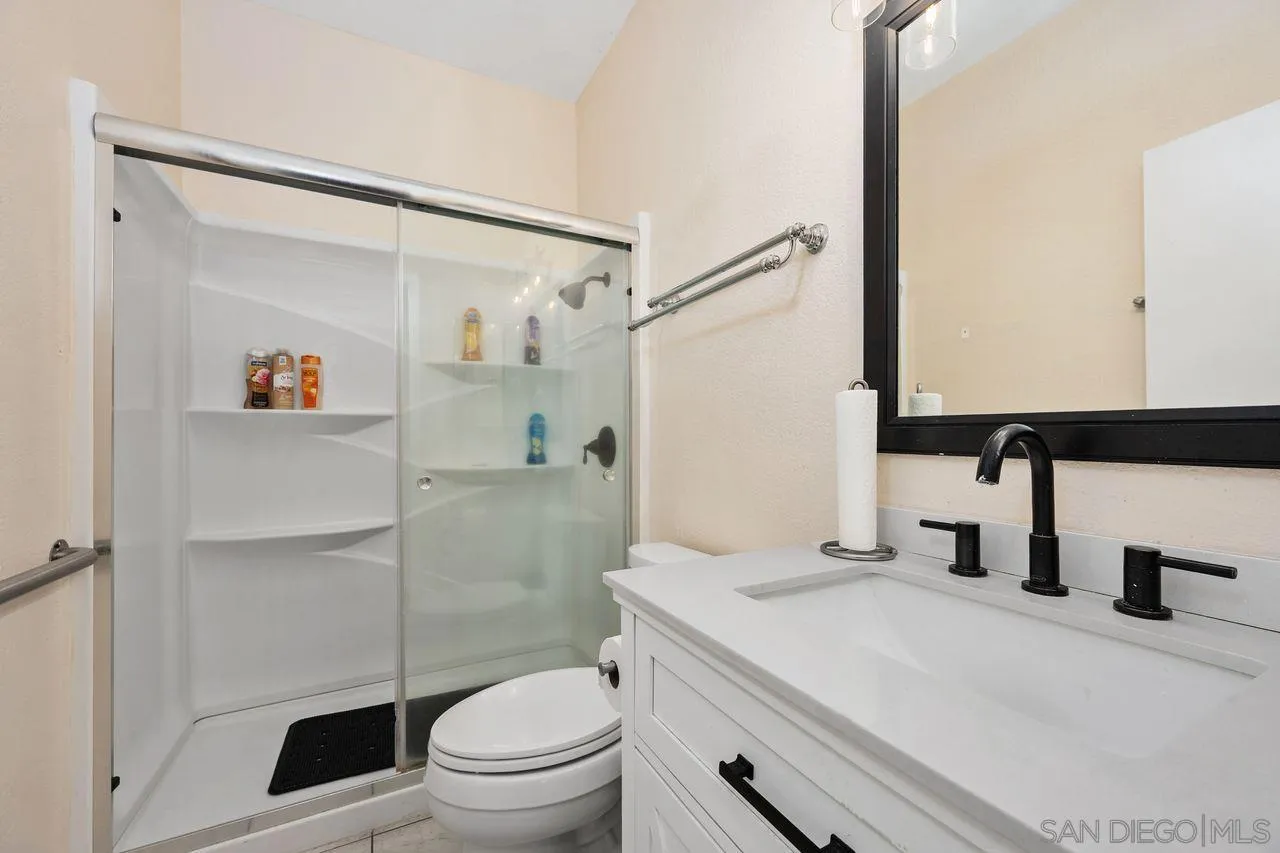 27497 Marian Road Temecula, CA 92591 - Photo 16 of 39 a bathroom with a sink a toilet and shower