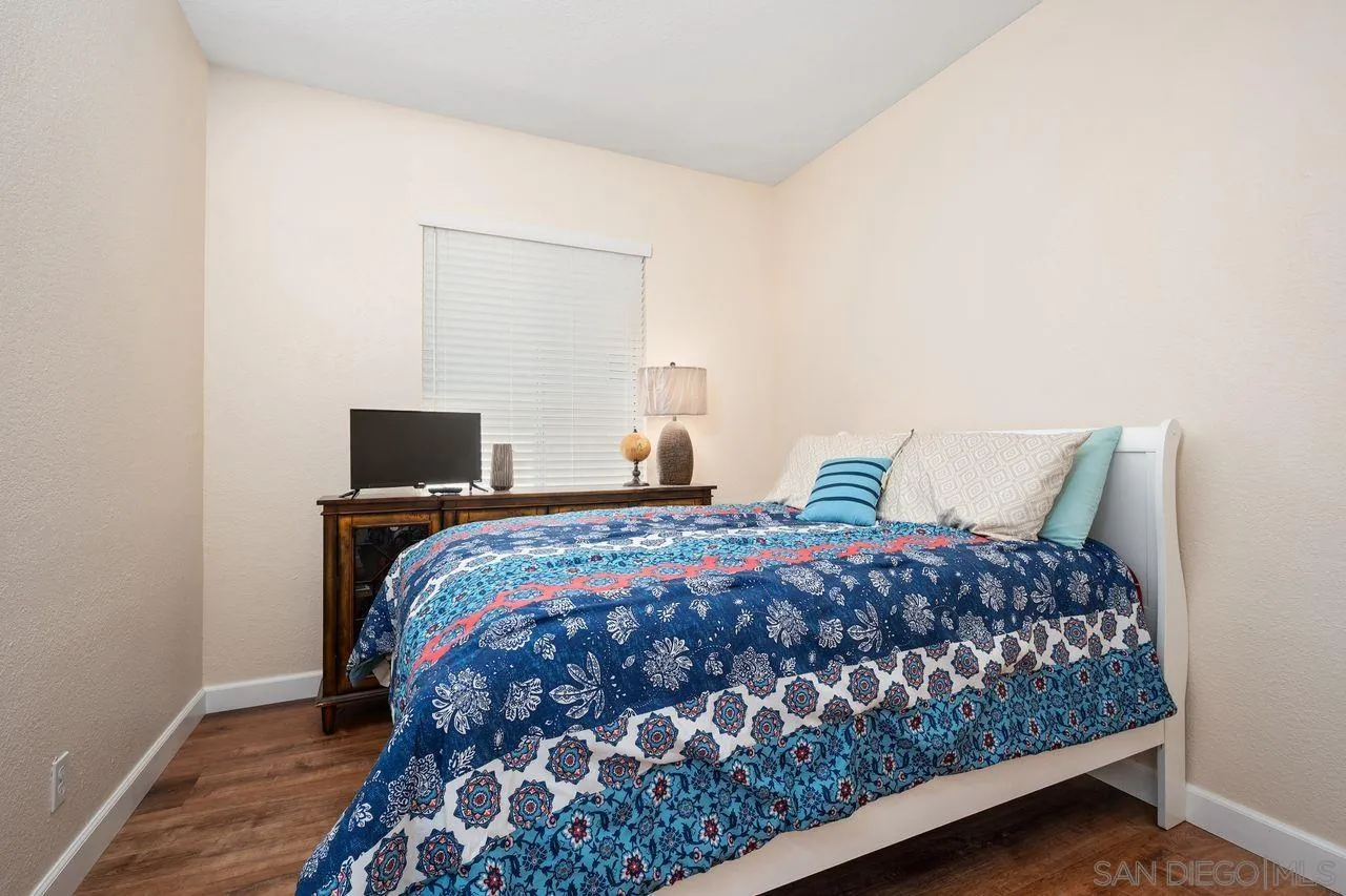 27497 Marian Road Temecula, CA 92591 - Photo 17 of 39 a bedroom with a bed and wooden floor