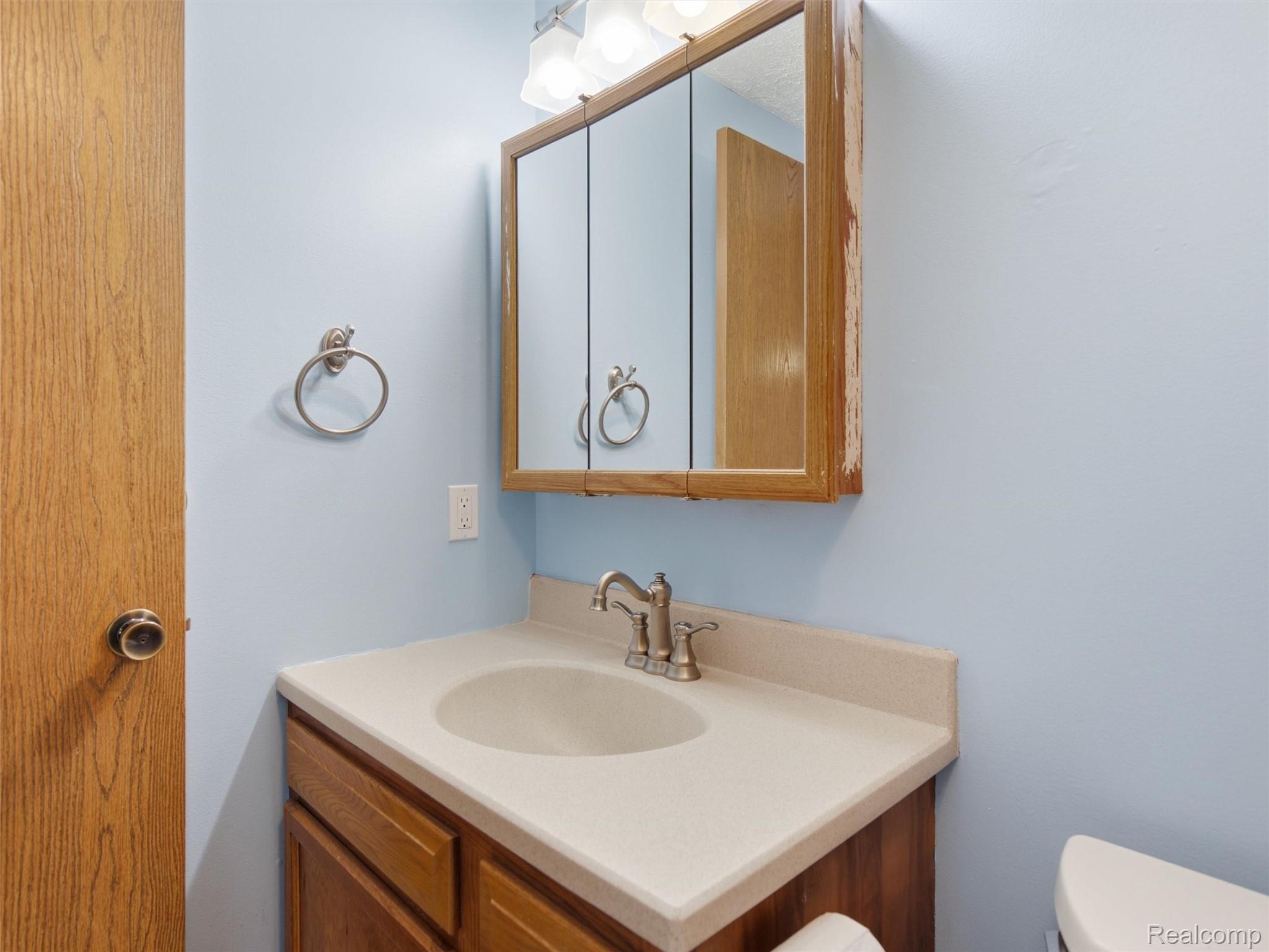 5003 Mason Road Howell, MI 48843 - Photo 20 of 59 Bathroom vanity featuring a light-colored countertop with an integrated sink and brushed nickel faucet