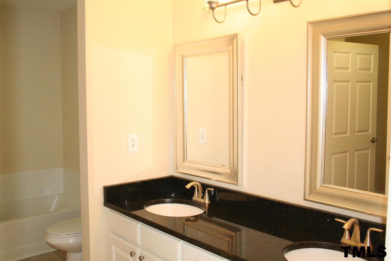 2500 Huntscroft Lane, Unit 101 Raleigh, NC 27617 - Photo 12 of 22 a bathroom with a sink a toilet and a window