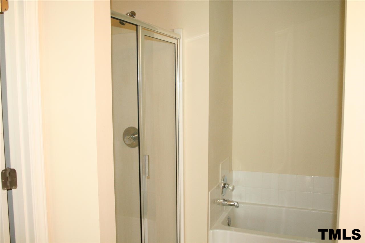 2500 Huntscroft Lane, Unit 101 Raleigh, NC 27617 - Photo 13 of 22 a bathroom with a shower and a glass door
