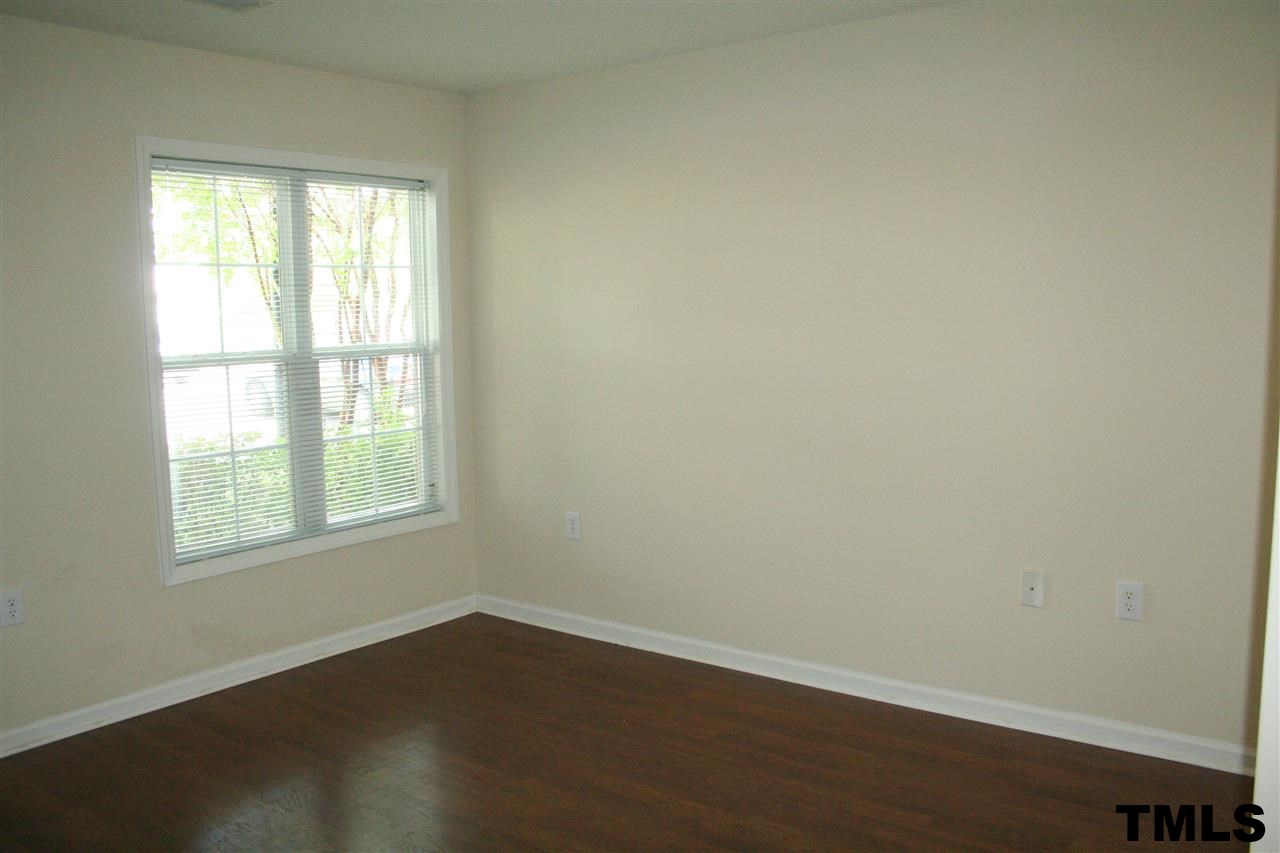 2500 Huntscroft Lane, Unit 101 Raleigh, NC 27617 - Photo 17 of 22 an empty room with wooden floor and windows