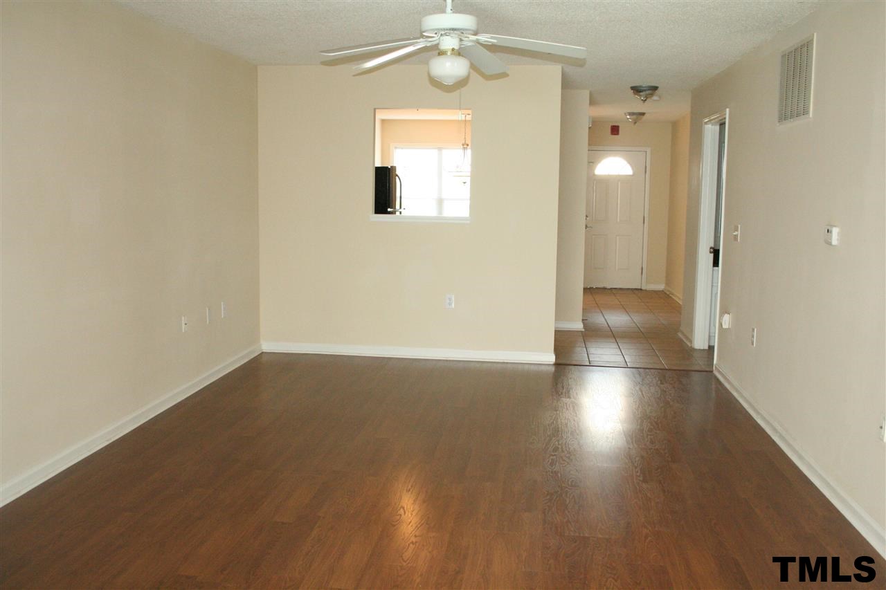 2500 Huntscroft Lane, Unit 101 Raleigh, NC 27617 - Photo 6 of 22 an empty room with wooden floor and windows