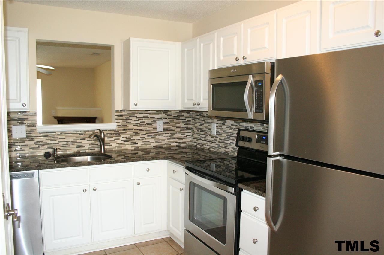2500 Huntscroft Lane, Unit 101 Raleigh, NC 27617 - Photo 7 of 22 a kitchen with granite countertop a refrigerator sink and stove