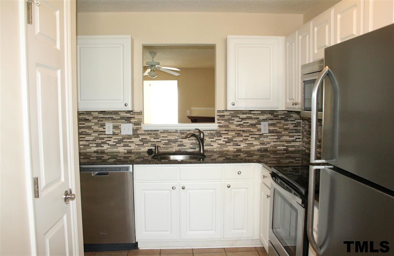 2500 Huntscroft Lane, Unit 101 Raleigh, NC 27617 - Photo 9 of 22 a kitchen with stainless steel appliances granite countertop a refrigerator and a stove