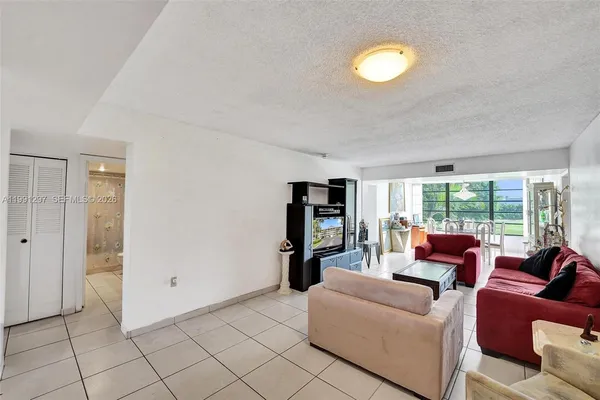 a living room with furniture fireplace and flat screen tv