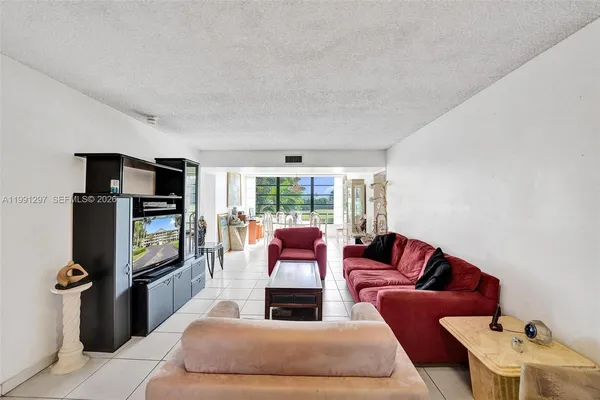 a living room with furniture fireplace and a window
