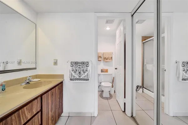 a white toilet sitting next to a bathroom sink