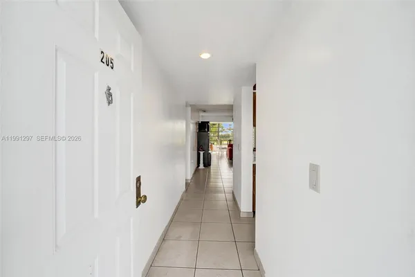 a view of a hallway with wooden shelves