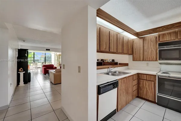 a kitchen with stainless steel appliances granite countertop a sink and cabinets