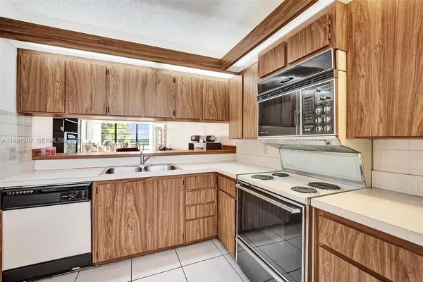 a kitchen with a sink stove and cabinets