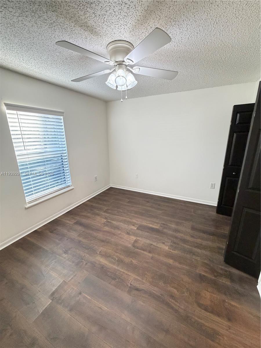7 Zeidler Place Palm Coast, FL 32164 - Photo 14 of 26 an empty room with wooden floor fan and windows