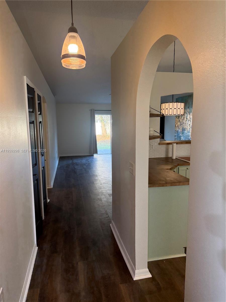 7 Zeidler Place Palm Coast, FL 32164 - Photo 2 of 26 an empty room with wooden floor mirror and windows