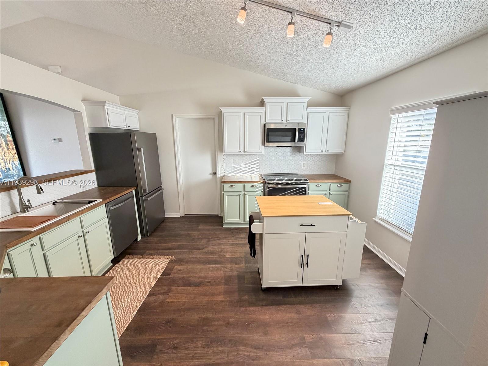 7 Zeidler Place Palm Coast, FL 32164 - Photo 3 of 26 a kitchen with a refrigerator stove and sink