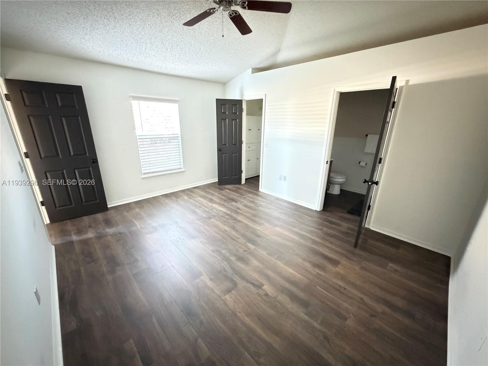 7 Zeidler Place Palm Coast, FL 32164 - Photo 9 of 26 an empty room with wooden floor and windows