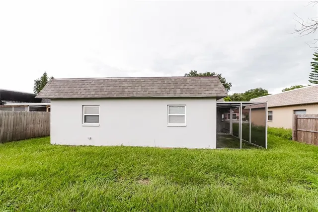 a view of backyard of house with green space