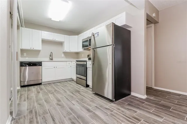 a kitchen with a refrigerator and a sink