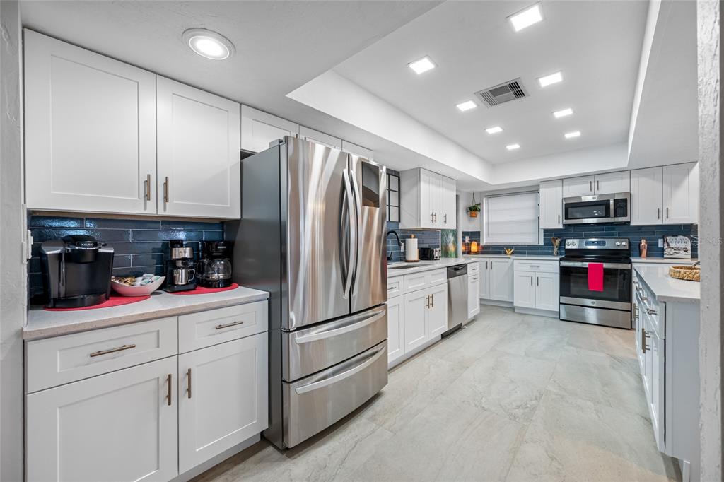 2153 Karan Way Clearwater, FL 33763 - Photo 15 of 65 a kitchen with refrigerator a microwave and cabinets