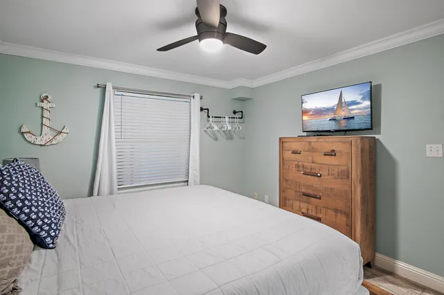 a bedroom with a bed and a tv on the dresser