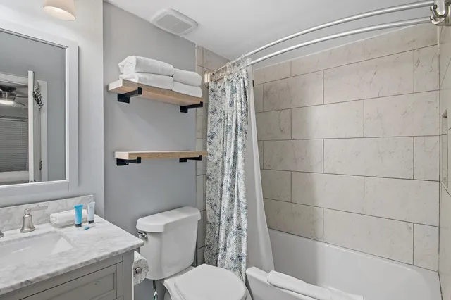 a bathroom with a sink toilet and shower
