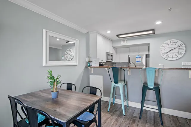 a view of a dining room with furniture and wooden floor