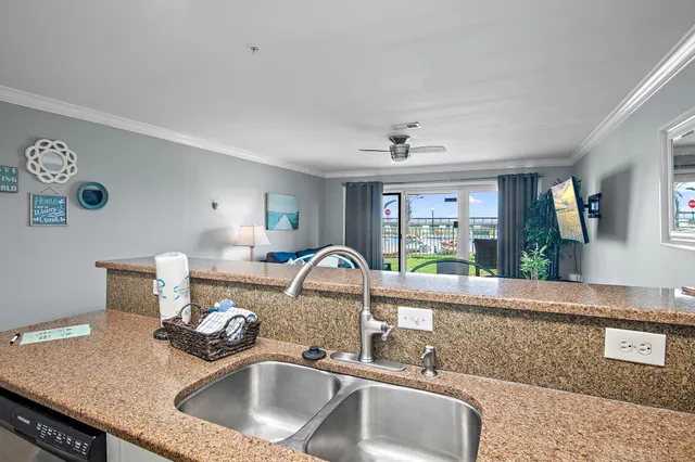 a kitchen with a sink a stove and a refrigerator