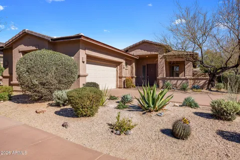 a front view of a house with a yard and outdoor seating