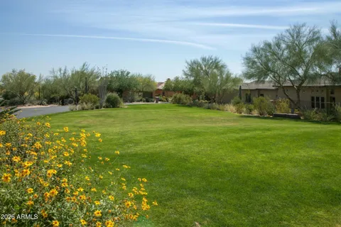 a backyard of a house with table and chairs